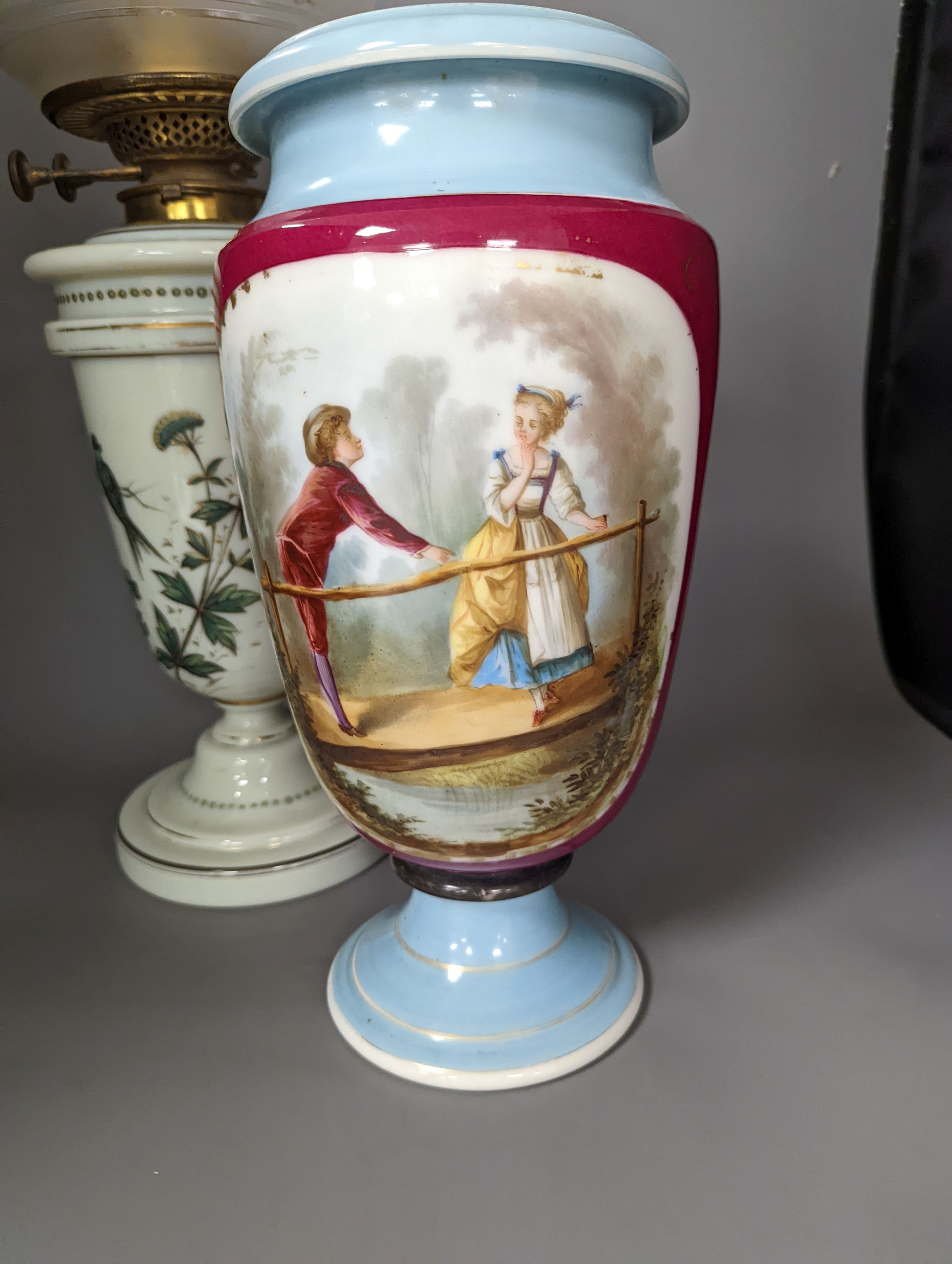 A late 19th century French enamelled green glass oil lamp and glass shade and a Paris porcelain vase, Oil lamp 61 cms high.